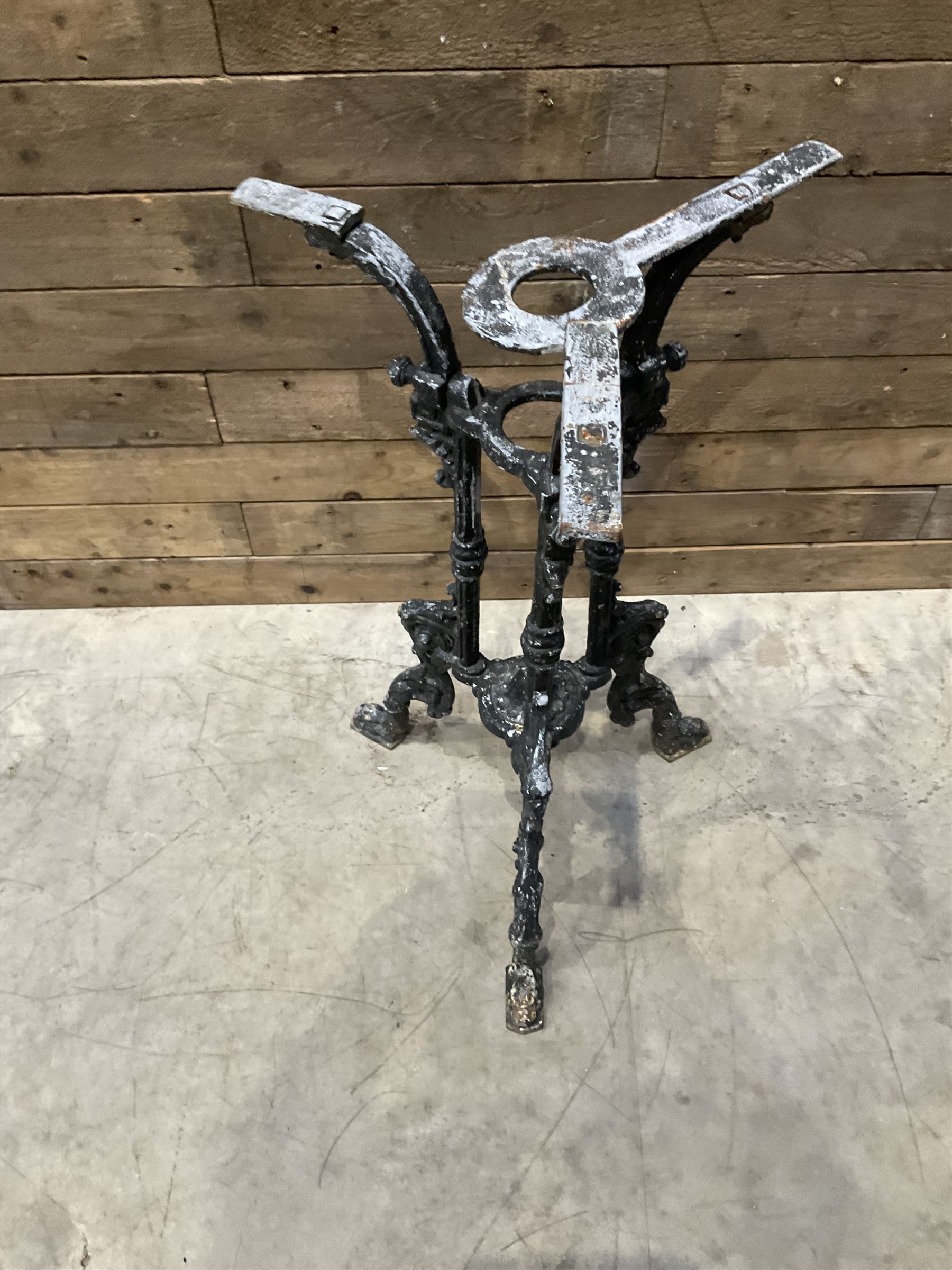 19th century cast iron table base, trefoil column with paw feet