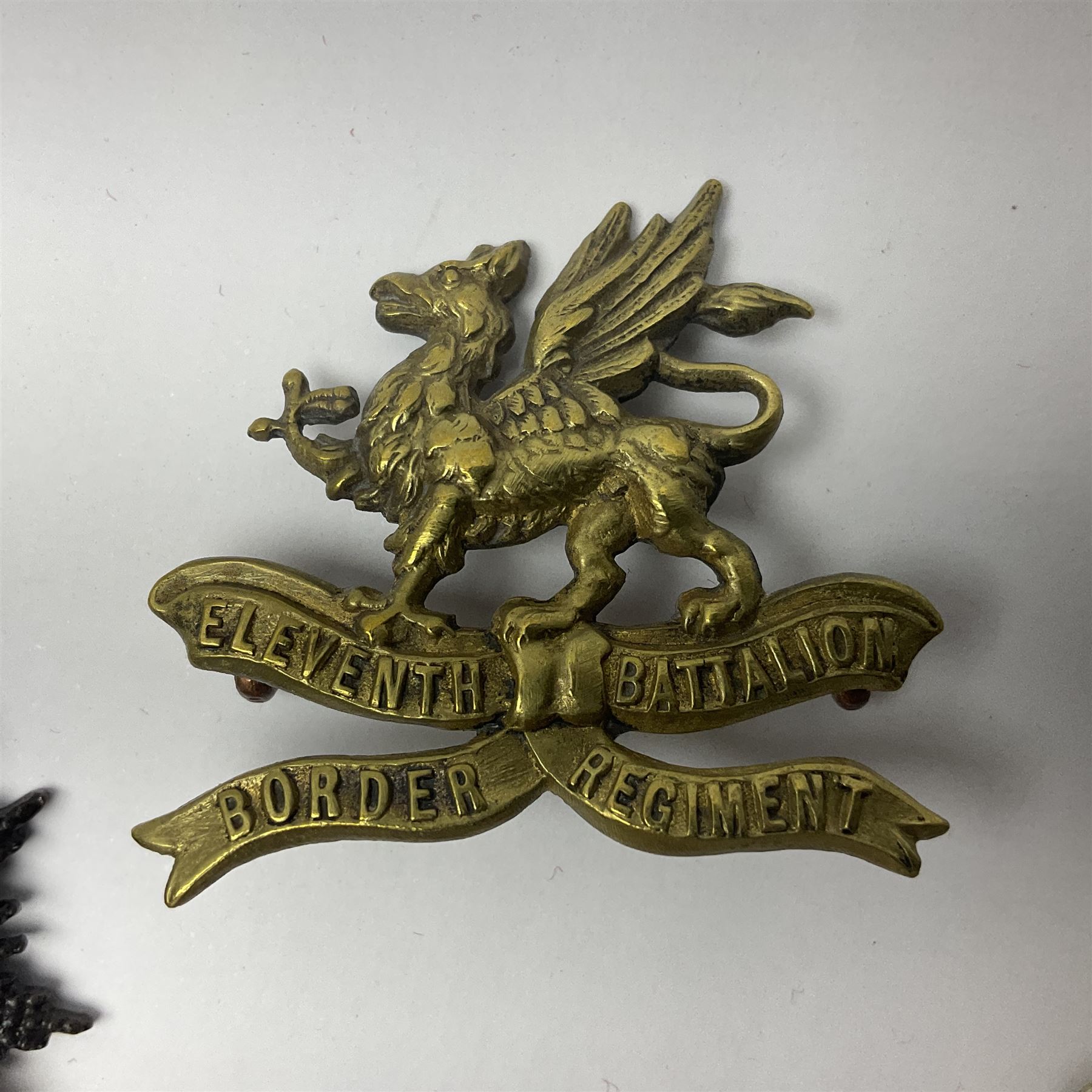 Four Border Regiment cap badges including eleventh battalion (4)