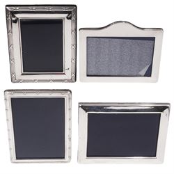 Four modern silver mounted photograph frames, all of rectangular form with easel supports verso, two with reed and ribbon borders, all hallmarked, largest H18cm W14cm