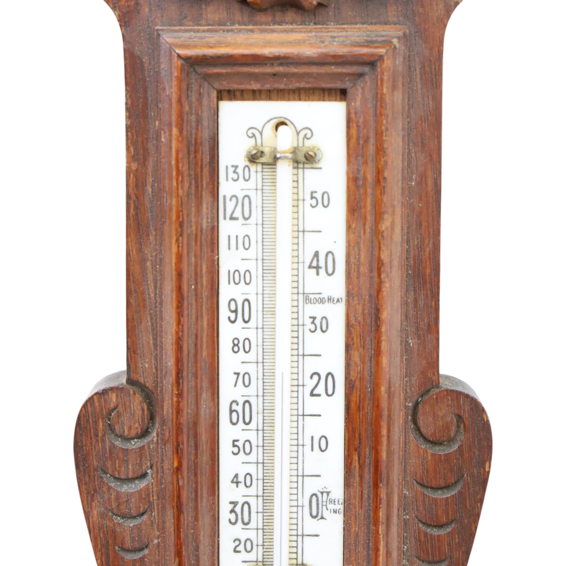 Victorian carved oak aneroid barometer, the foliate crest above a glazed thermometer, with scroll carved sides and circular dial below, H  60cm