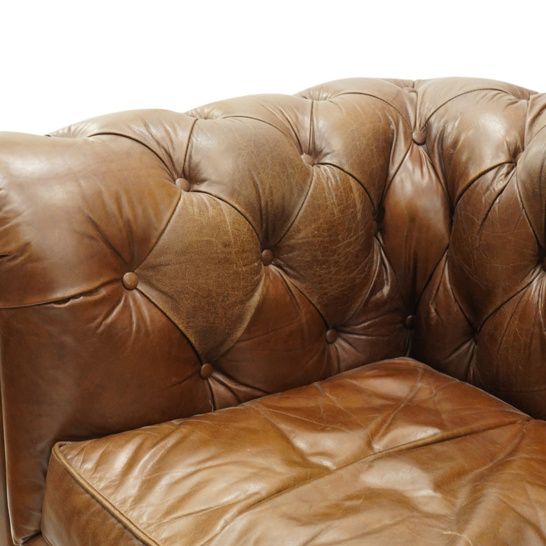Timothy Oulton for Halo - two seater brown leather chesterfield settee, of traditional shape with rolled back and arms, upholstered in back-buttoned tan leather with loose seat cushions, raised on turned feet
