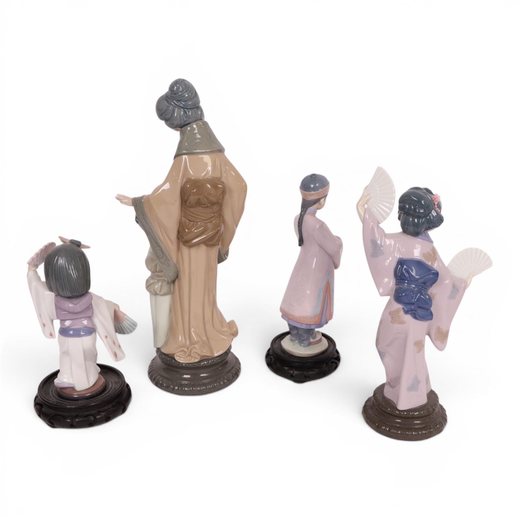 three Lladro figures, comprising Oriental Dancer 6230, Japanese with Fan 4991, Asian Boy 6188 and a Nao figure Mother and Child   