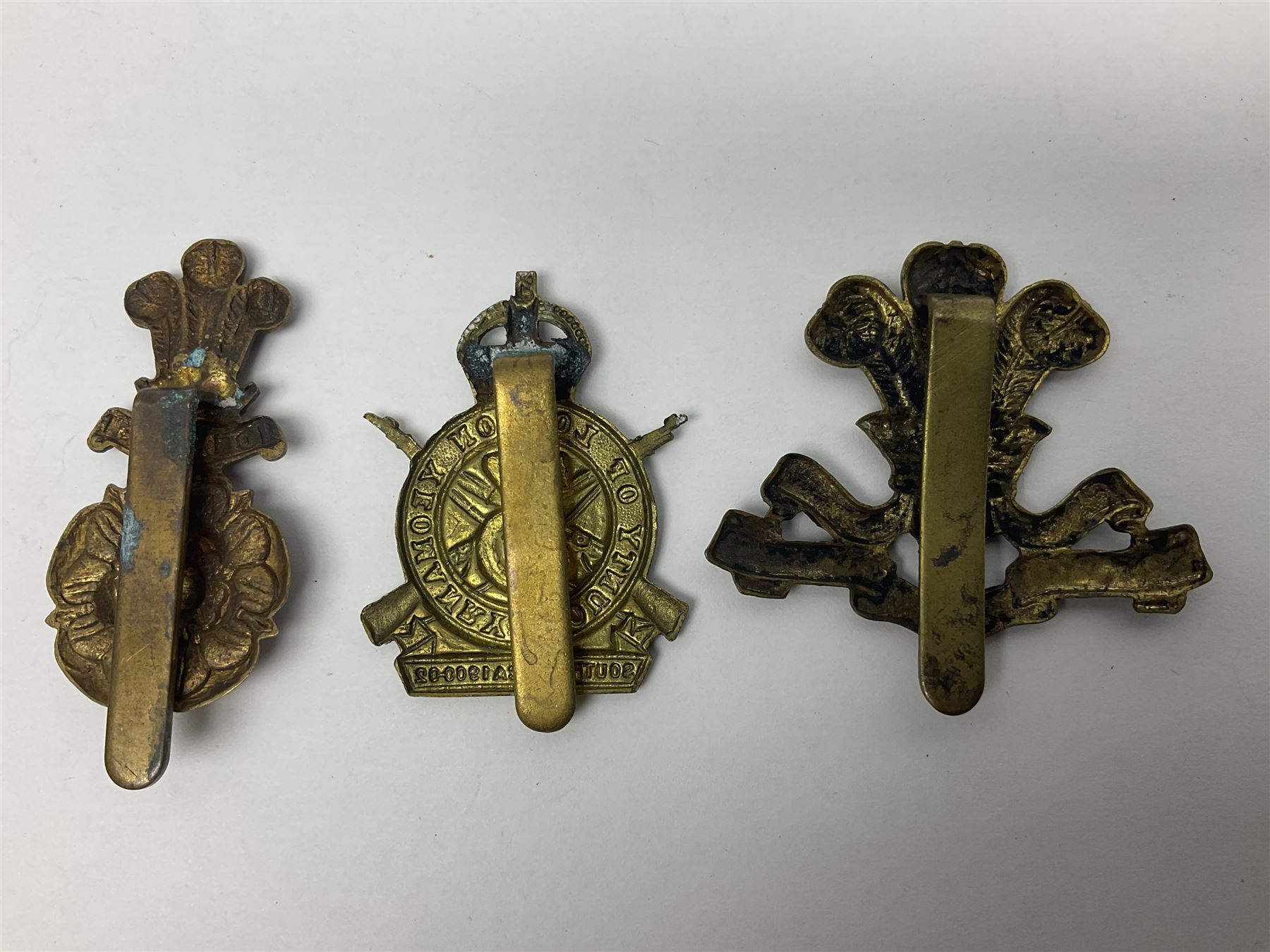 Nineteen Yeomanry metal cap badges including Derbyshire, Northamptonshire, Essex, Glamorgan, Staffordshire, City of London, Surrey, Shropshire, Hertfordshire etc; together with eleven Fusiliers badges including Lancashire, Royal Welch, Northumberland etc (30)