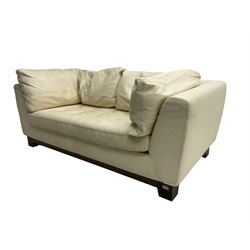 Roche-Bobois - two seat sofa, upholstered in ivory leather with buttoned seat cushions, raised on a stained beech base with bracket feet