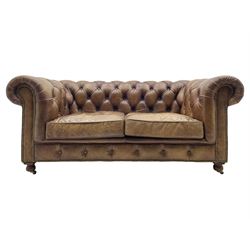 HALO - Chesterfield style two seat sofa upholstered in buttoned brown leather with stud work, on turned feet with castors