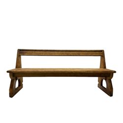Late 19th century pine pew or bench, single bar back over plank seat and sledge feet