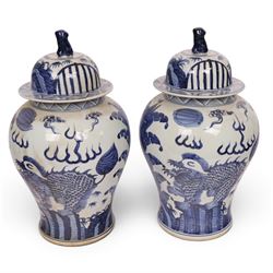 Pair of blue and white Chinese vase and cover, of baluster form, decorated with dragons, the cover with a fo dog finial, H15cm