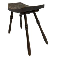 Late 19th century oak stool, rectangular dished top relief carved with floral lunettes and central insignia, on turned splayed supports