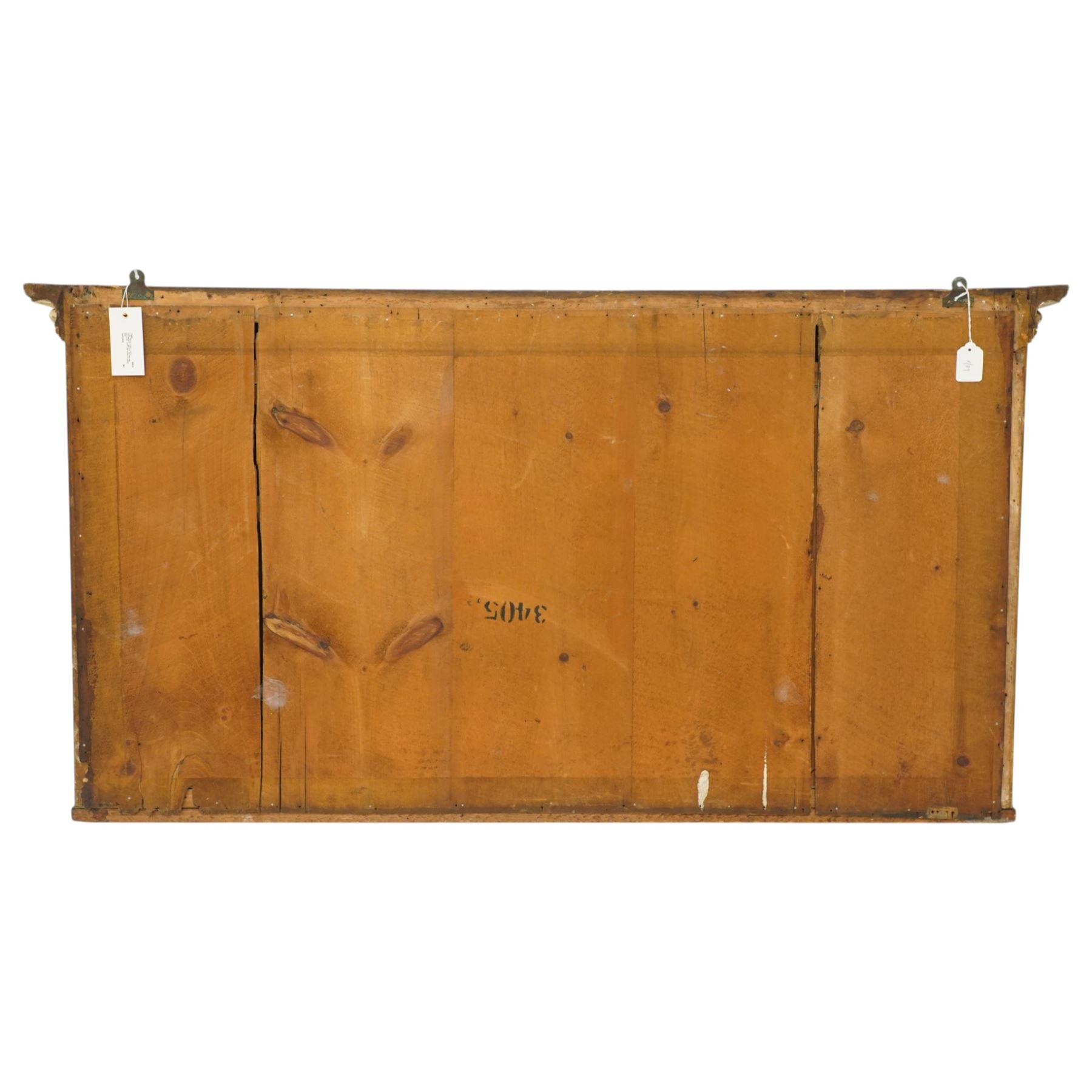 Regency period gilt and gesso framed tripartite overmantel mirror, projecting cavetto cornice applied with globular mounts, the frieze carved with repeating scallop and floral urn motifs, flanked by canted cluster-column pilasters with acanthi capitals, the triple rectangular bevelled plates within reeded slips, on skirted ebonised base
