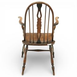 Early 20th century Windsor armchair, the arched hoop back enclosing a pierced and shaped splat flanked by turned spindles, above a shaped elm seat and outswept arms on turned supports, raised on turned legs united by an H stretcher