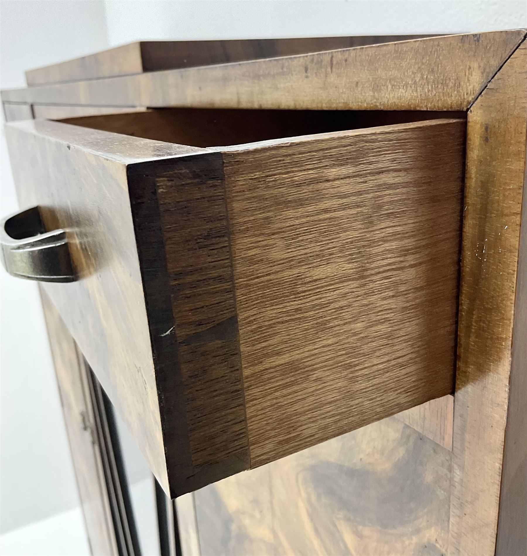 Art Deco walnut display cabinet, central astragal glazed door flanked by two drawers and two cupboards 