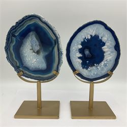Pair of blue agate slices, polished with rough edges raised upon gilt metal stands, H22cm