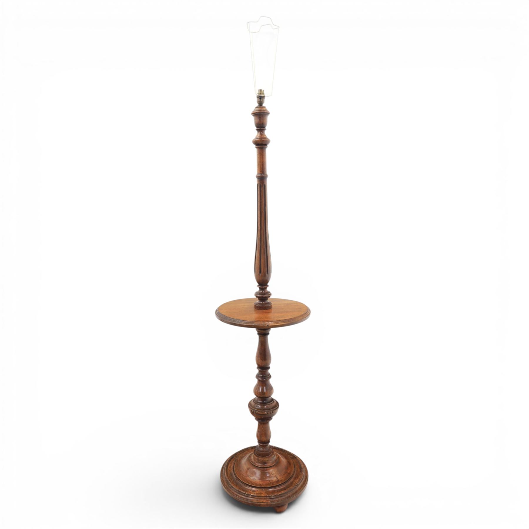 Late Victorian set of two oak standard lamps, turned and carved column supports, one with foliate carved panelled stem, on stepped square bases with carved scroll feet, the other on circular moulded spreading base
