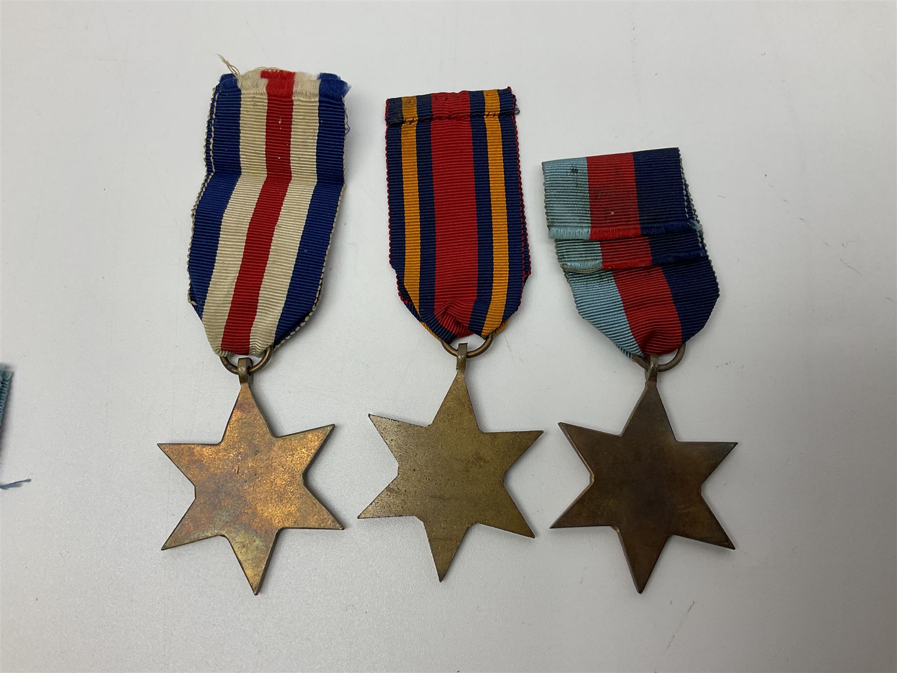 Ten WW2 medals comprising two 1939-1945 war medals, two Defence medals, two 1939-1945 Stars, two Africa Stars, France & Germany Star and Burma Star; together with bar of four miniature medals; all with ribbons