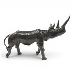 African carved hardwood ebonised figures of a rhinoceros and hippopotamus, each with stylised incised detail and polished dark finish, largest H 61cm, W 91cm)
