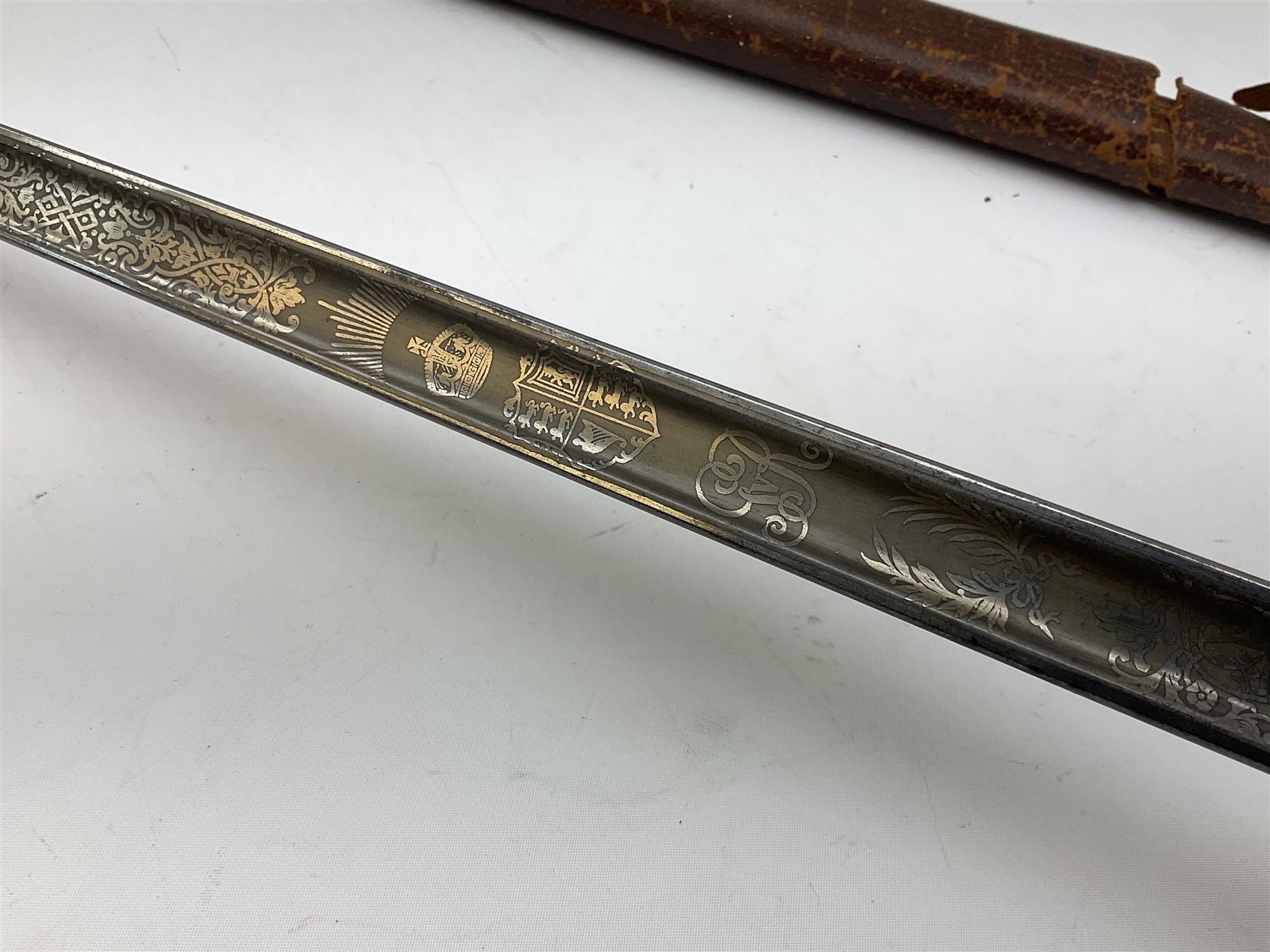 British George V 1897 Pattern Infantry Officers Sword, the 82.5cm fullered steel blade etched and polished with crowned royal arms, GRV cyphers and scrolling foliage, marked Army & Navy Co-operative Society 105 Victoria St London SW to the ricasso,  plated pierced basket hilt with wire bound fish skin grip and leather knot, No.15032; in leather covered scabbard