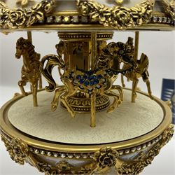 Franklin Mint House of Faberge; The Faberge Imperial Carousel Egg, with a carousel that revolves to the sound of the musical box operated by the winding key finial, H27cm