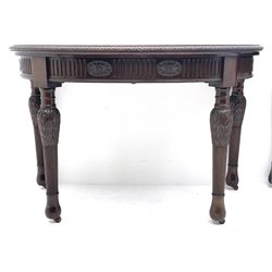 Pair early 20th century Hepplewhite style mahogany D-end console tables, the curved top with foliate carved edge, fluted frieze rails carved with flower heads, turned and reeded acanthus supports with recessed castors