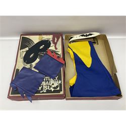 Two Boxed Batman Playsuit Costumes - 1960s 20th Century Original Play Suit, black eye mask, plastic vinyl cape/gauntlets, leather style belt, blue/yellow shirt, with Bat motif and blue/yellow pants; in original illustrated lidded box; and 1976 Decker Batman Playsuit costume, vinyl cape/ mask/gloves/boot tops/yellow belt, grey cloth top and pants; in original illustrated box (2)