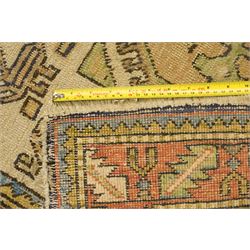 Two Caucasian designed rugs comprising a flatweave and hand-knotted rug, Caucasian design flatweave, cream ground with three large blue geometric medallions surrounded by stylised birds and geometric motifs, enclosed by repeating geometric border, fringed ends, H176cm, W102cm; hand-knotted Caucasian rug, ivory ground with three polychrome octagonal medallions surrounded by stylised animals, flowerheads and geometric motifs, enclosed by salmon pink geometric border, fringed ends, H163cm, W106cm