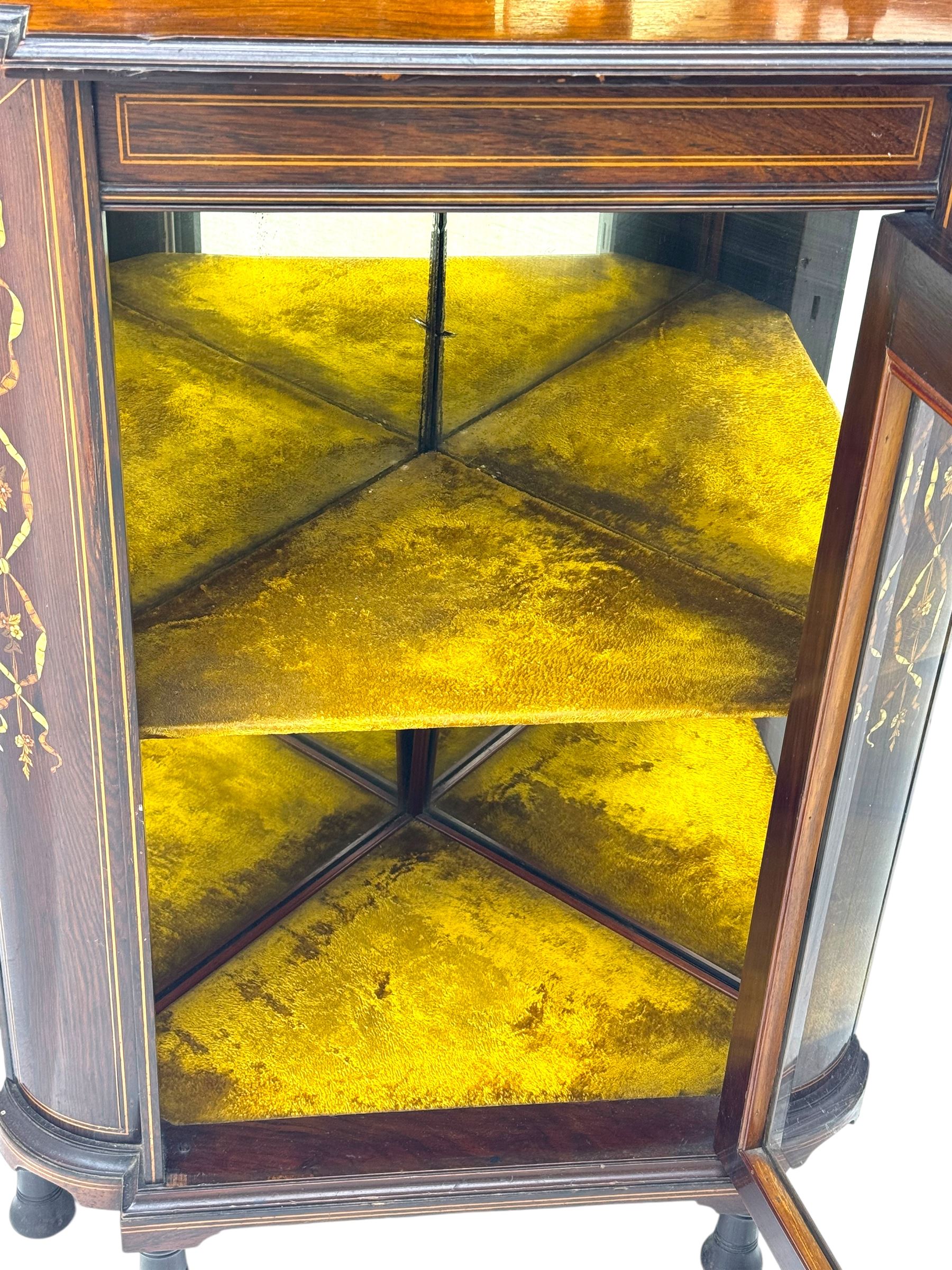 Late 19th century inlaid rosewood free standing corner display cabinet, the upper section featuring a mirrored panel above an inlaid cupboard with a felt-lined interior, complemented by a recessed open compartment with a mirrored back, the base with a glazed door enclosing two felt-lined shelves, on turned supports
