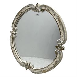 French design carved pine wall mirror, the frame in the form of conforming c-scrolls, plain mirror plate, in distressed white paint finish 