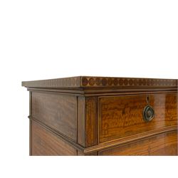 Waring & Gillow - Edwardian Sheraton Revival satinwood sideboard, shaped and stepped break bow-front, the top with central oval book-matched veneered panel and rosewood banding, the front and return edges inlaid with a single row of repeating circles, three frieze drawers each inlaid with rosewood band and ebony stringing, two cupboards flanking open centre, the doors inlaid with lozenges and satinwood cross bandings, on faceted octagonal supports with foliate carved collars, terminating to turned feet, the central drawer with 'Warings' metal plaque and stamped 'Gillows'