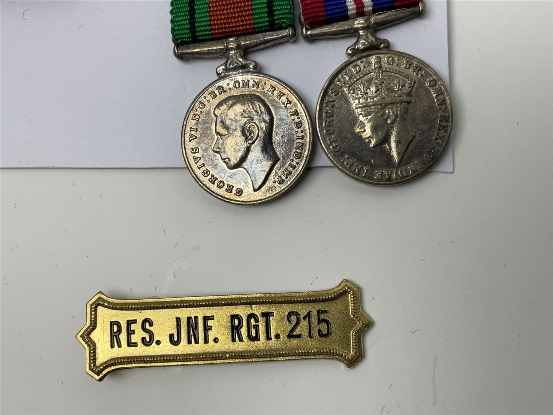 Eleven medal miniatures including Turkish Crimea, OBE (Civil), WW2 Burma Star and France/Germany Star, two pairs of WW2 War/Defence medals, LSGC etc; and two military badges