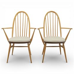 Ercol - elm dining chairs, set of six including two armchairs, arched spindle backs over shaped elm seats with upholstered pads, tapering beech legs joined by stretchers