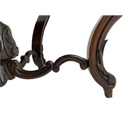 19th century Irish rosewood centre table, the shaped and moulded top over shaped apron carved with scrolled foliage, on serpentine supports carved with bell flowers, the supports united by anthemion carved finial and s-scroll x-framed stretchers