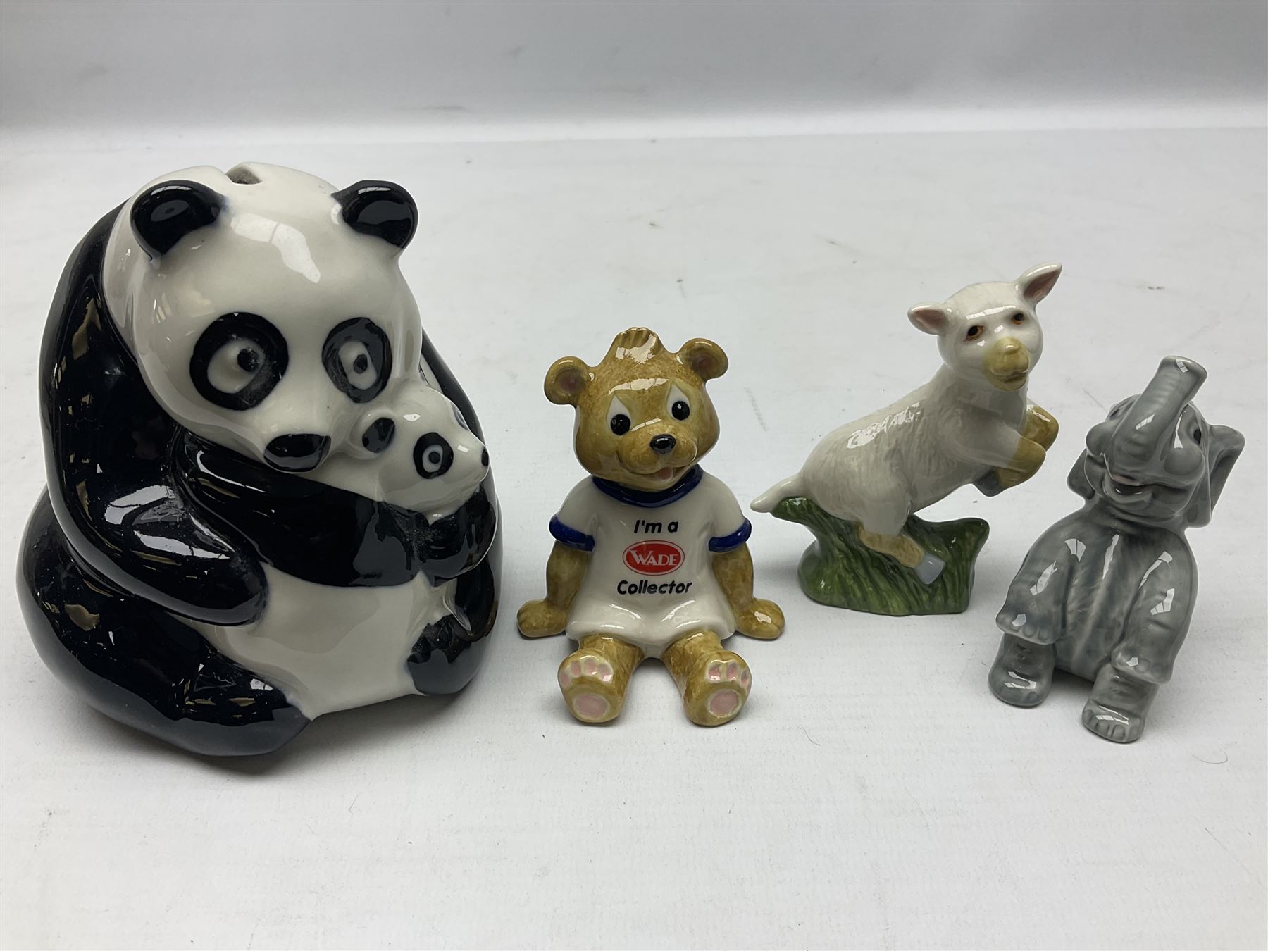 Nine Wade Collectables figures, comprising six Myths and Legends; King Canute, Mermaid, St George, Cornish Tin Mine Pixie, Puck and Green man, together with Lamb, Elephant and bear, a Wade Panda money box and two boxes of Wade Christmas Crackers