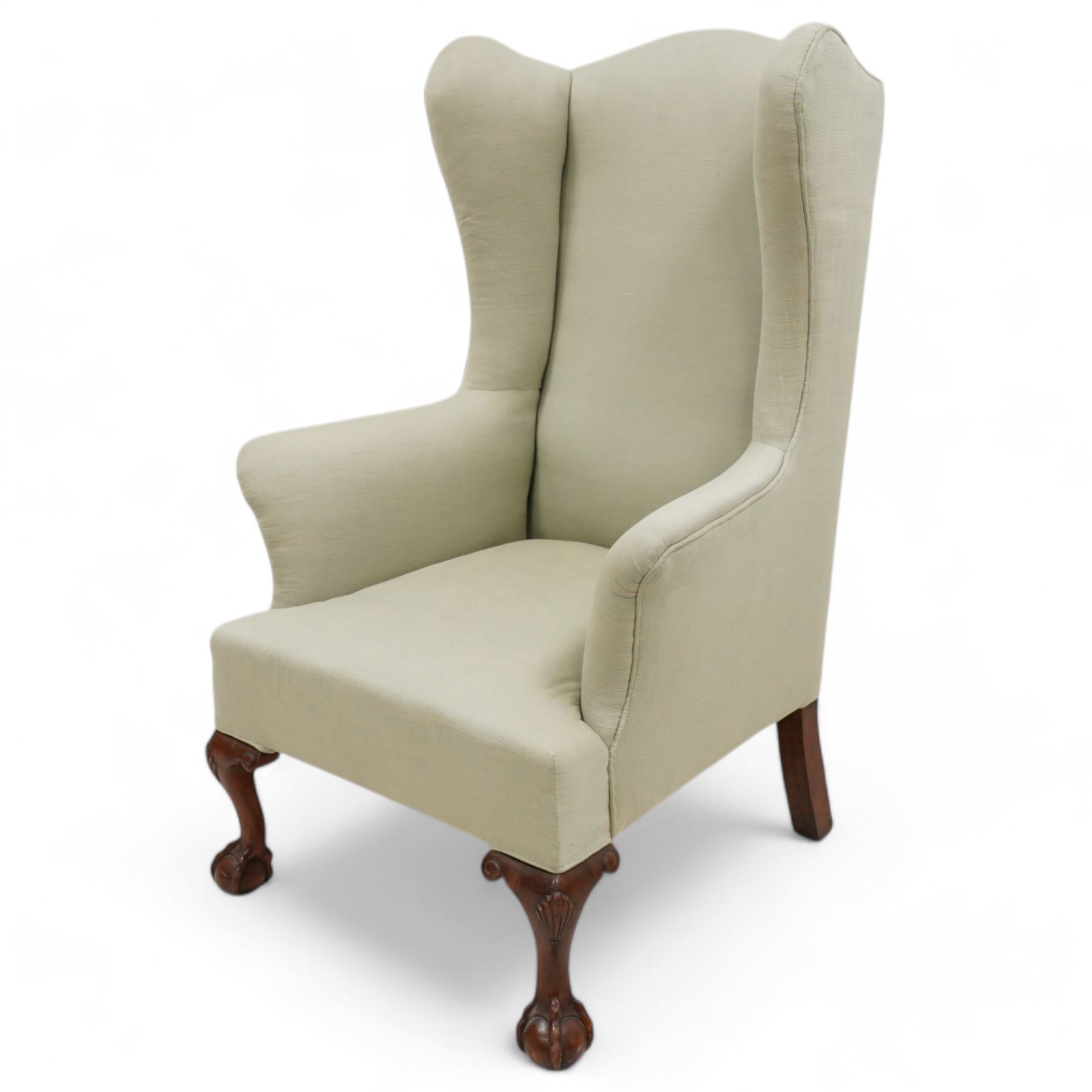 Queen Anne design hardwood framed wingback armchair, upholstered in sage green fabric, on shell carved ball and claw feet