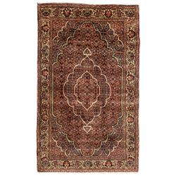 Persian Bidjar crimson ground rug, thick woollen pile, the field decorated with repeating Herati motifs within cusped outlines, the guarded border decorated with repeating flower head motifs