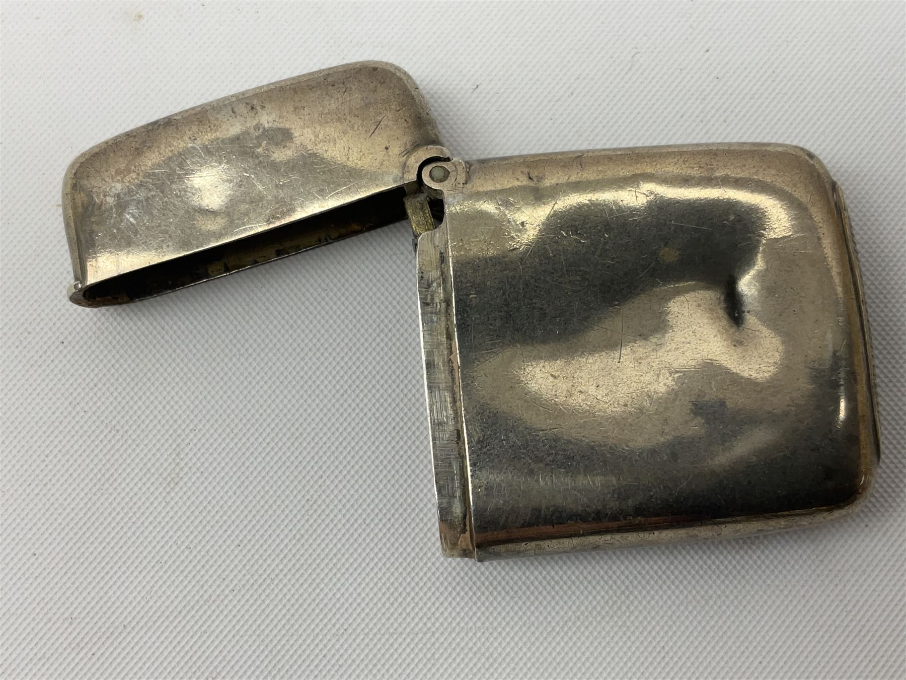 Victorian novelty brass vesta case modelled in the form of a pig holding a money bag, together with a silver vesta, hallmarked 