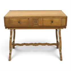 Leemings of Halifax (est. 1872) - Arts & Crafts oak side table, rectangular caddy top with raised moulded back, the frieze carved with central Yorkshire rose motif flanked by two drawers, raised on twin stylised lyre end supports formed of C-scrolls, united by shaped stretcher