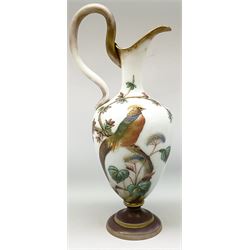 Victorian Aesthetic movement milk glass ewer, the body hand painted with an exotic bird upon a cured branch, the rim, handle and base with remnants of gilt, with painted numbers beneath, H35.5cm