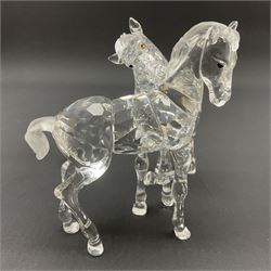 Five Swarovski Crystal horses, comprising stallion, rearing horse, pair of horses playing and Arabian stallion, each with frosted manes and tails, together with a small Swarovski Crystal galloping horse, the mane, tail and base with smoky tint