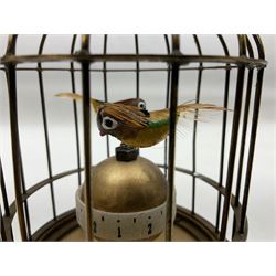 Automation bird cage clock of predominantly brass construction with central rotating orb and two birds with feathered decoration, H19cm