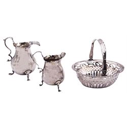 Small Victorian silver swing handled basket, of oval form with pierced sides, hallmarked Birmingham 1898, makers mark worn and indistinct, W11cm, together with a small Edwardian silver cream jug of slightly bellied form with scroll handle, upon three pad feet, hallmarked Henry Clifford Davis, Birmingham 1905, including handle H8cm, and a similar larger silver example, no visible hallmarks, approximate total weight 6.75 ozt (210.2 grams)