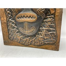 Copper panel embossed with a design of an African mask, H70cm, W50cm