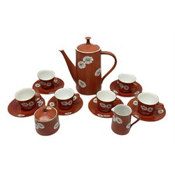 Noritake coffee set, decorated with white flowers upon a russet red ground, in one box 