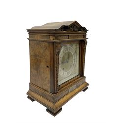 Lenzkirch - Late 19th century 8-day German mantle clock in a walnut veneered case with an architectural pediment, square brass dial, cast spandrels, matted dial centre, silvered chapter ring and fleur-di-Lis hands, with a twin train movement chiming the quarters on two coiled gongs and striking the hours on one. With Key and pendulum. Silver presentation plaque dated 1896.