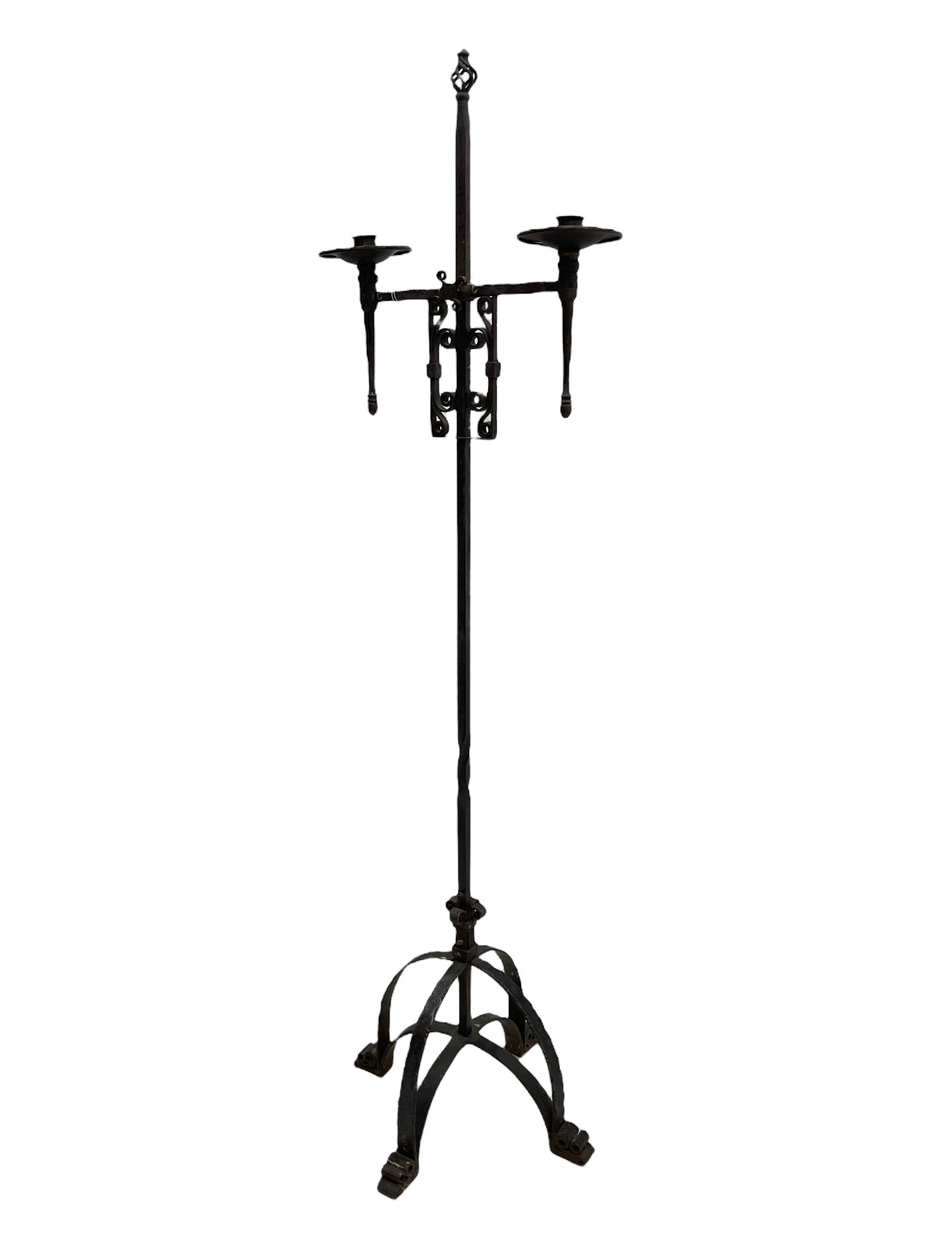 Ironwork candle holder stand, with stamped decoration, adjustable two branch sconces with scrolled iron work, twist stem with arched supports with scrolled terminals