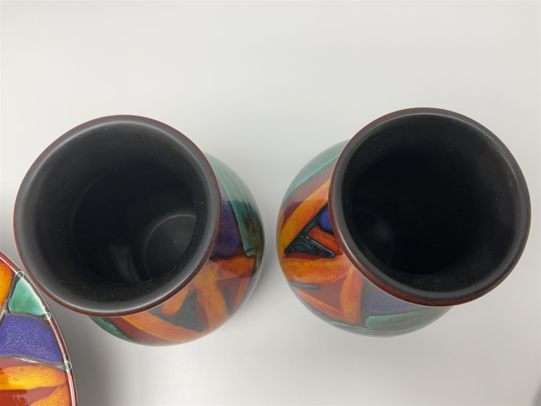 Four pieces of Poole Pottery in Graffiti pattern, comprising pair of vases of baluster form, dish and small plate, with impressed or printed marks beneath, vase H17cm