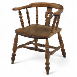 19th century ash and elm Windsor adapted armchair, continuous curved arm with turned spindle supports and shaped splat, saddle seat on turned legs united by crinoline stretcher