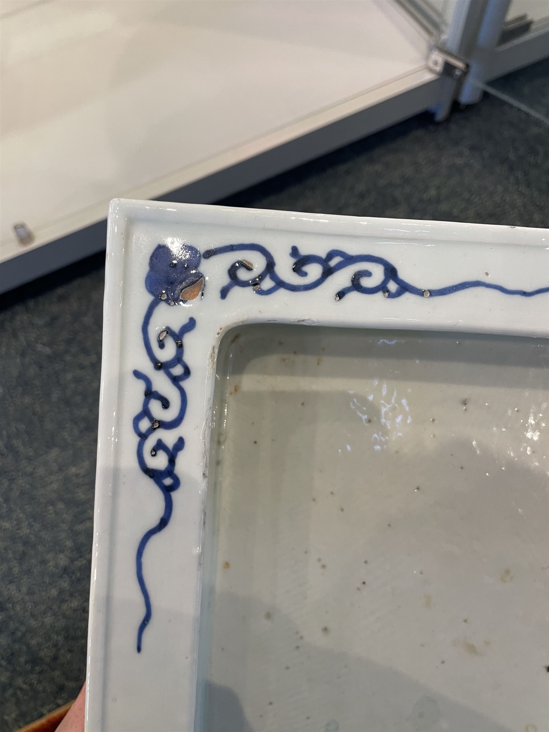 Chinese blue and white planter and stand, each of square slightly tapering and flared form, the planter decorated with two dragons and blossoming peonies, between stylised borders, the stand decorated with flower heads and vines, planter H30cm W29cm, stand H7cm D28.5cm