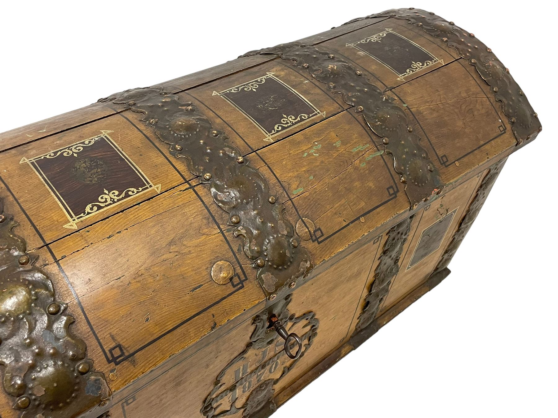 19th century painted oak sea chest, hinged dome top enclosing small compartment, bound by shaped and pressed metal strapwork, scumbled finish to resemble oak and painted with small vignettes depicting portraits and landscapes within panels, fitted with large wrought metal carrying handles, the front inscribed 'H.J.S. 1870' 