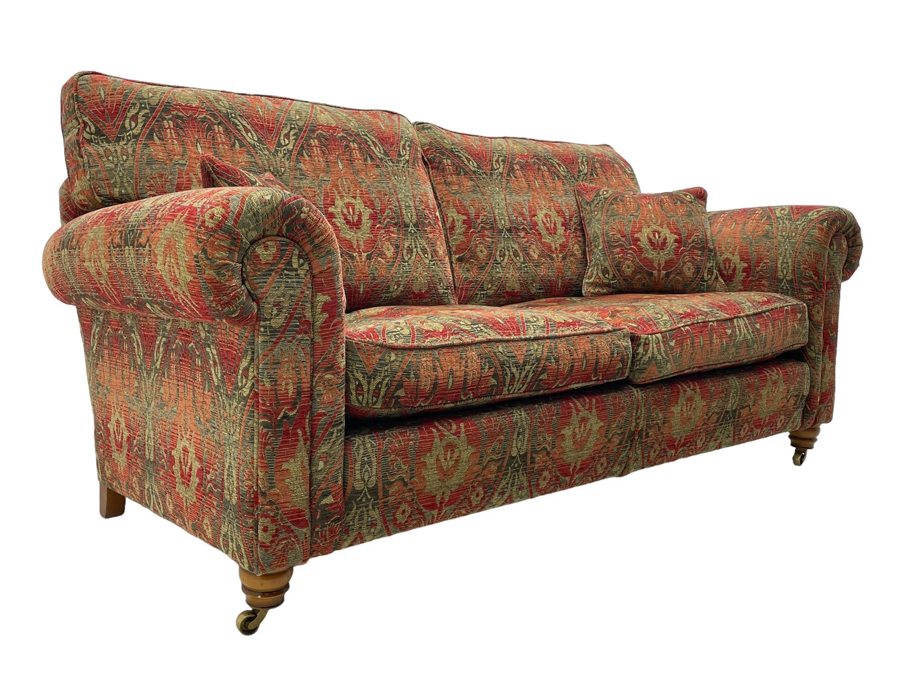 Duresta - 'Beaminster' grande two-seat sofa, traditional shape with rolled arms, upholstered in 'Althorp' russet and stone floral pattern fabric, on turned feet with brass castors

