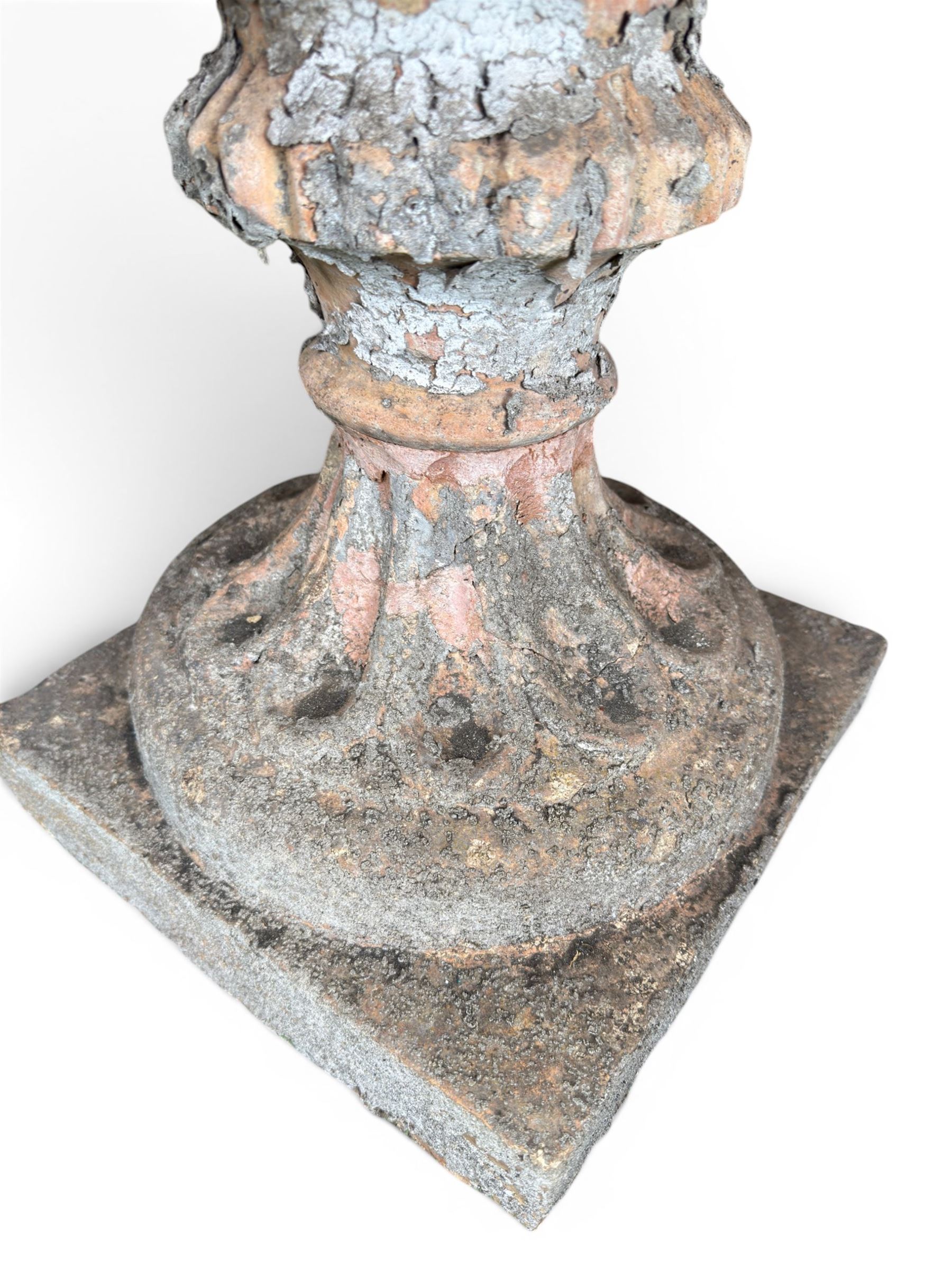 19th century terracotta campana shape urn planter, egg-and-dart moulded rim over a cherub-mask and gadrooned underbelly, turned pedestal and socle on square base