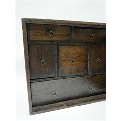 17th/18th century oak spice cabinet, the geometric moulded door opening to reveal a fitted interior with six drawers with ring handles, H29cm L33cm D20cm